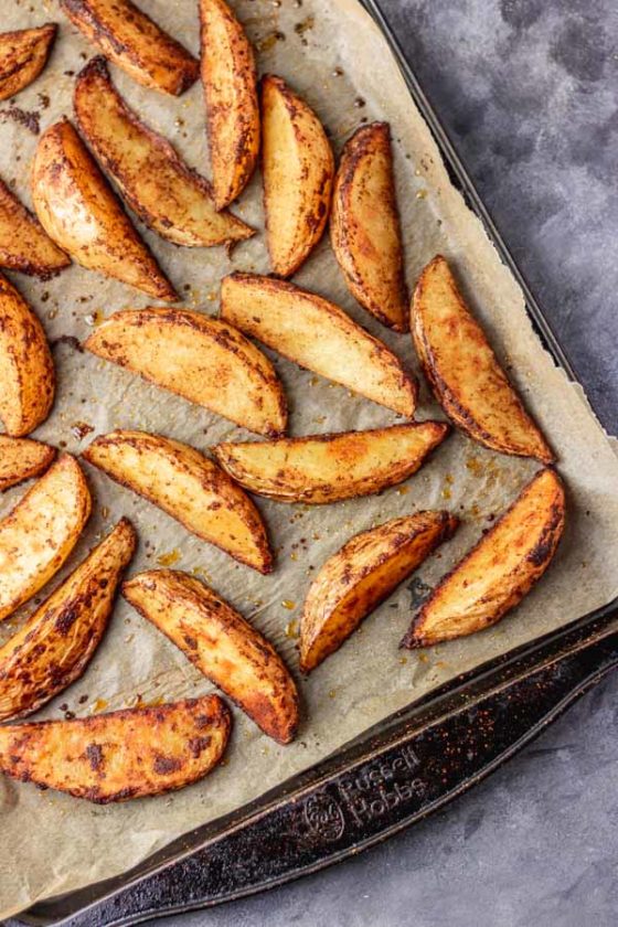 freshly baked crispy potato wedges out of the oven.