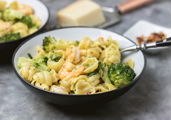 a bowl of broccoli pasta recipe with shrimps.
