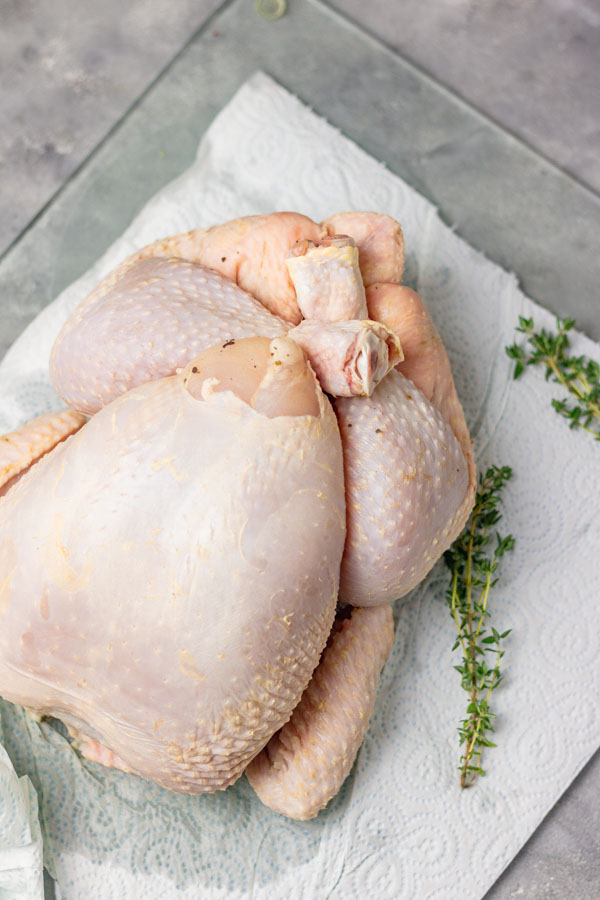 brined chicken placed on a kitchen towel waiting to be roasted