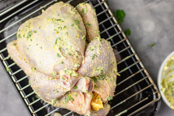 a whole 2 kg chicken rubbed with herb butter.