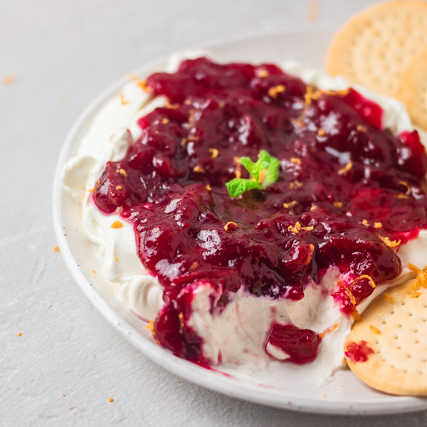 cranberry cream cheese garnished with orange zest and served with crackers.
