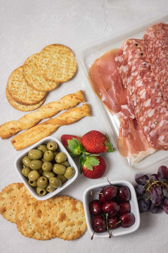 cured meats, crackers, olive and fruits for cheese board.