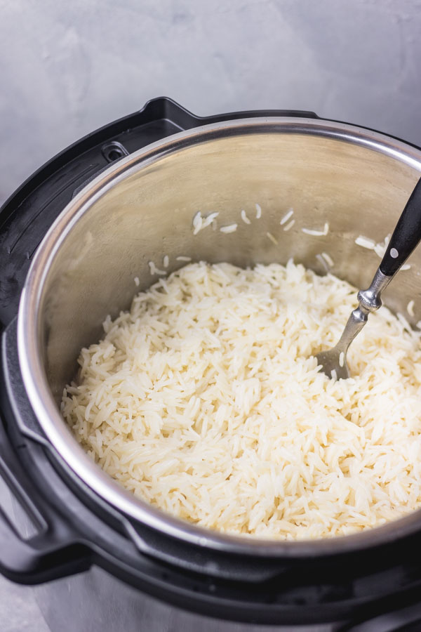instant pot rice fluffed with a fork.