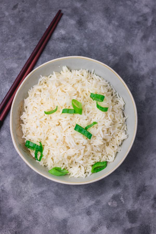 instant pot coconut rice in a bowl and chopsticks.