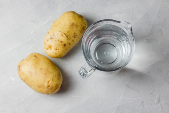 two large potatoes and a glass of water.