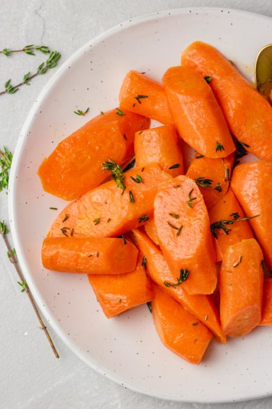 Instant pot steamed carrots garnished with thyme.