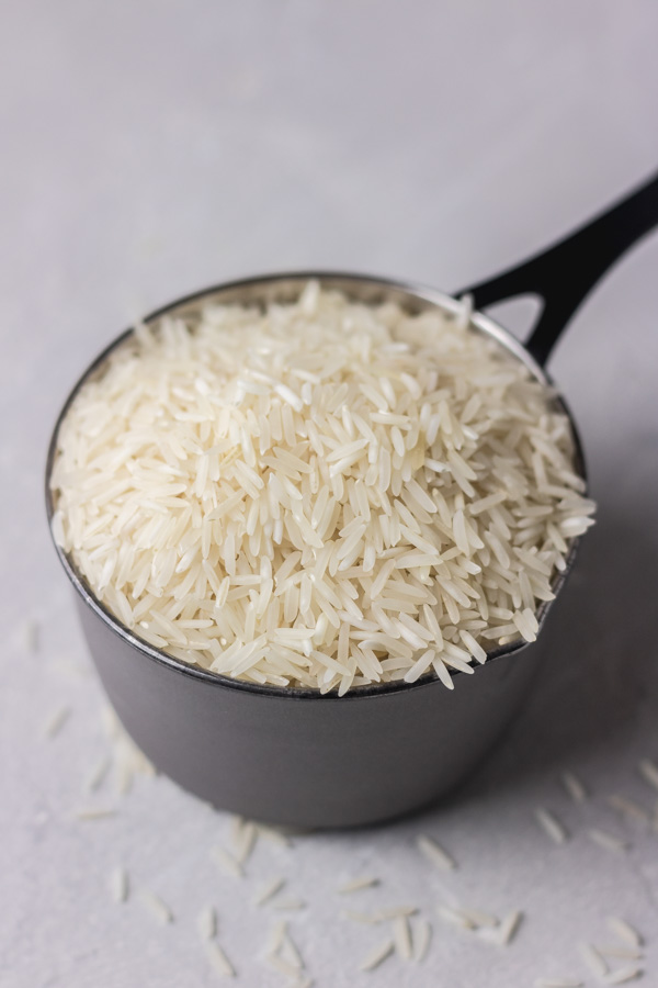 a cup of raw white indian basmati rice.