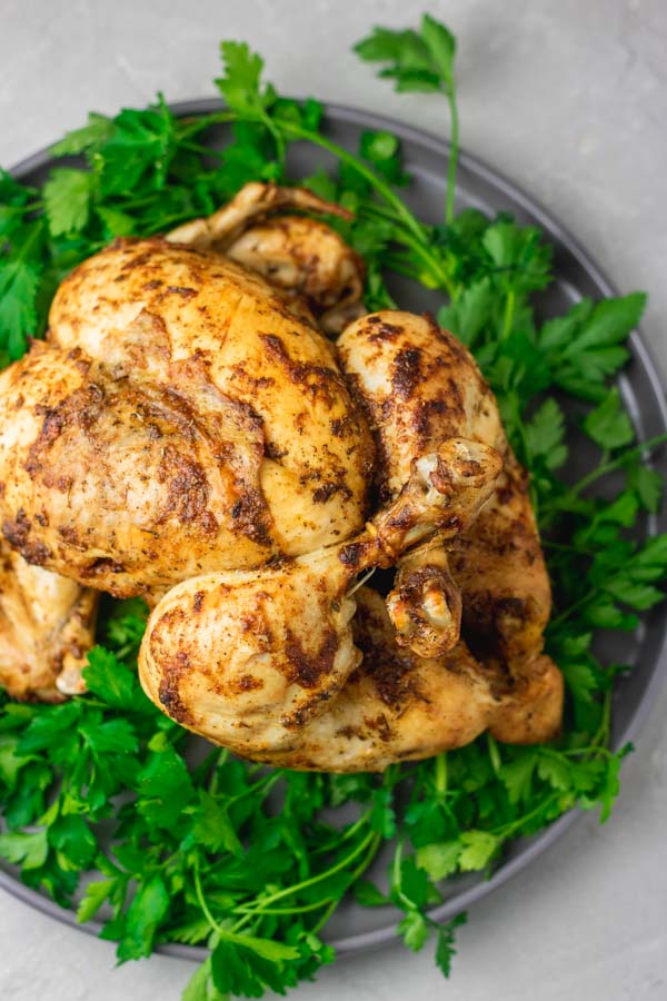instant pot whole chicken on a bed of parsley.