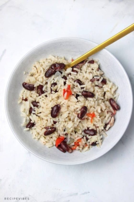 a white bowl containing boiled rice and red kidney beans.