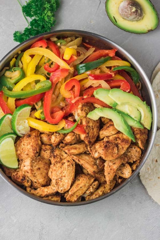 a pan of cooked chicken and peppers.
