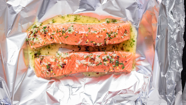 raw salmon covered with garlic butter sauce.