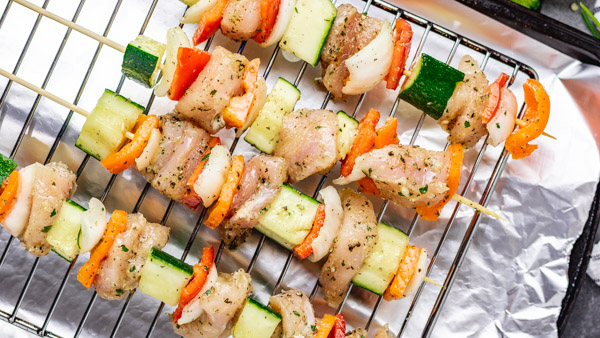 chicken skewers on a grilling rack.