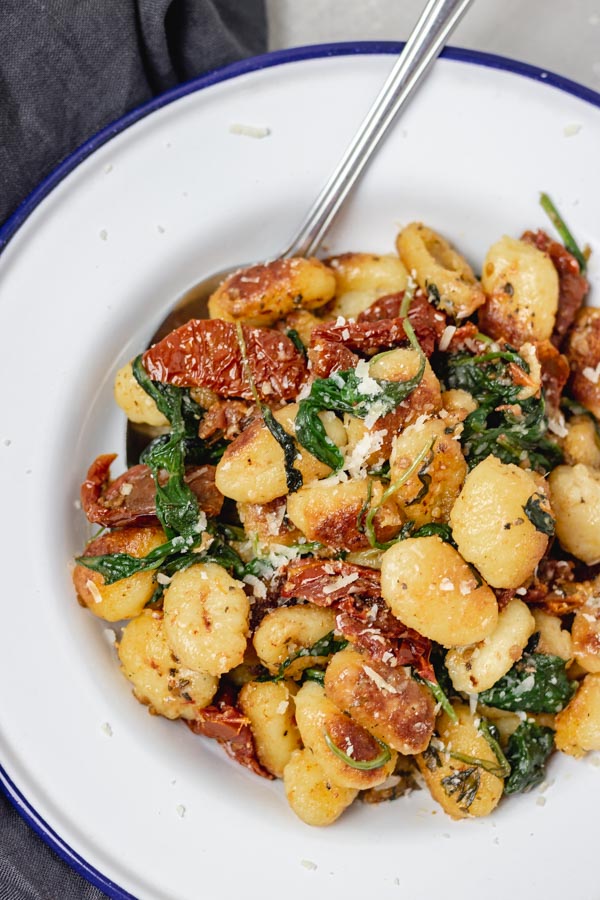 a plate of pan fried gnocchi.
