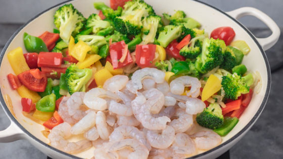 veggies and shrimps in a skillet.