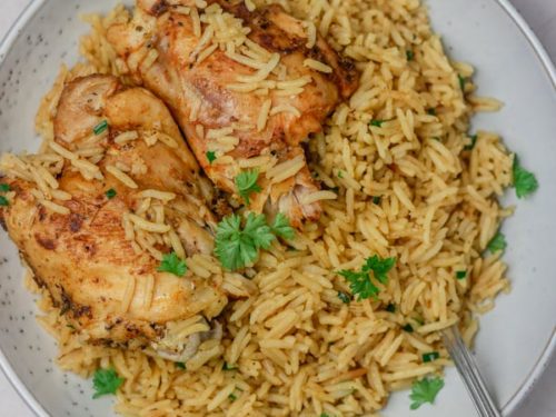 a plate of rice and chicken.
