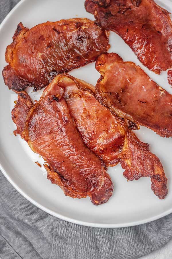 cooked bacon on a plate.