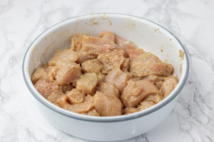 raw chicken pieces in an enamel bowl.