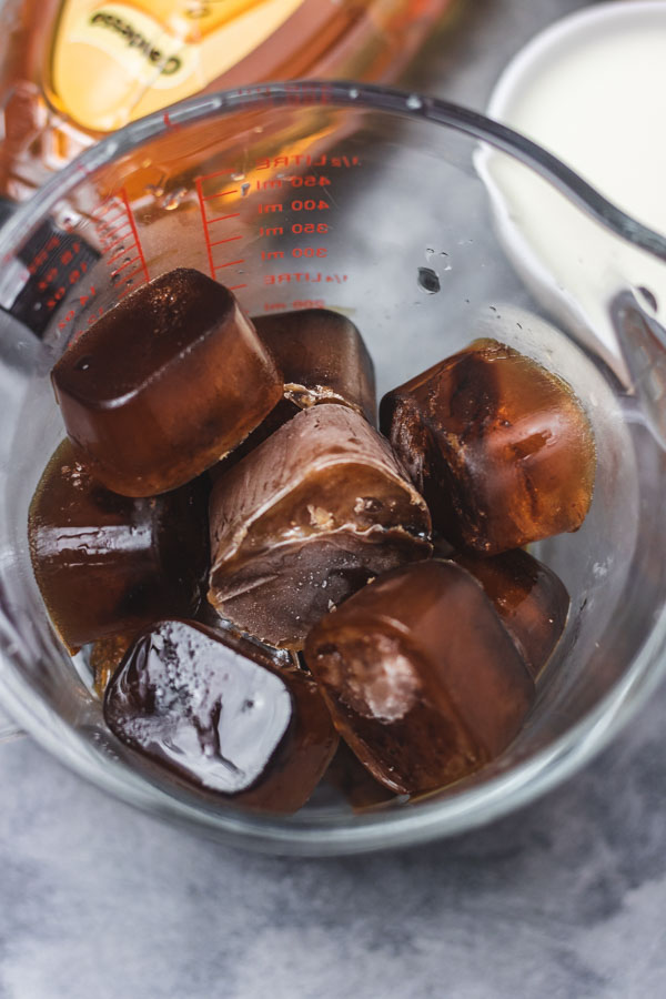 a glass of frozen coffee cubes.