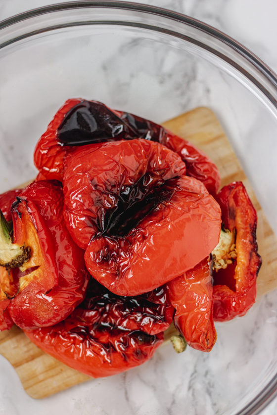 roasted red bell peppers in a glass bowl.
