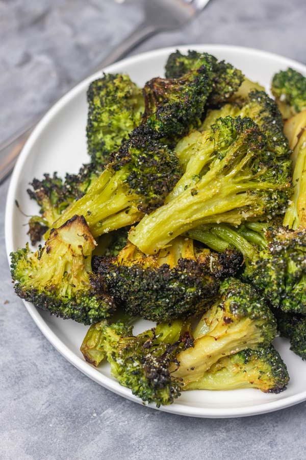 a plate of roasted broccoli florets. 