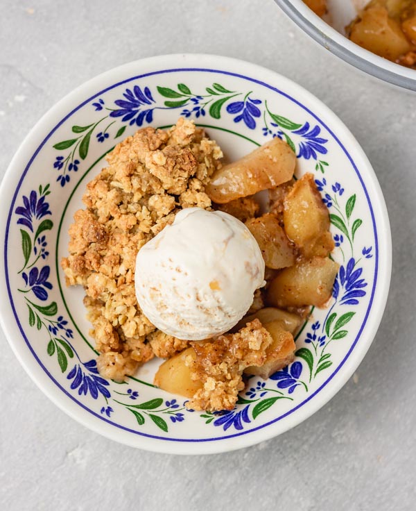 a small bowl of apple pie and a scoop of icecream.
