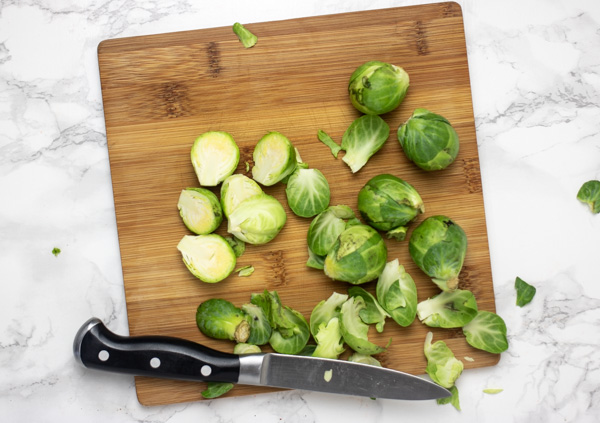 sliced brussels sprouts on a chopping board.