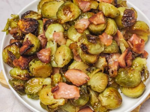 brussels sprouts and bacon on a side plate.
