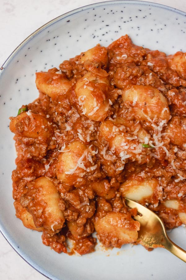 a plate of ground beef and gnocchi.