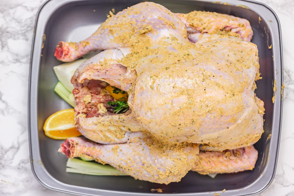 turkey rubbed with butter place in a roasting pan.