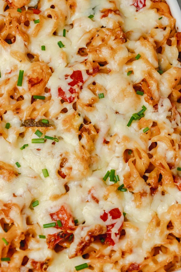 a close shot of pasta bake topped with melted cheese.