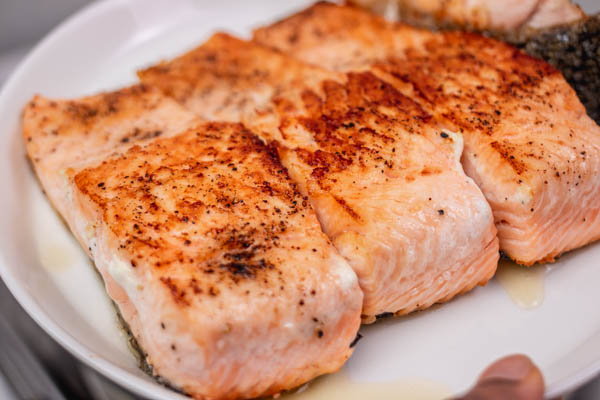 cooked salmon fillets on a plate.