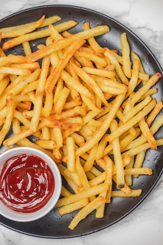 a plate of fried fries and ketchup.
