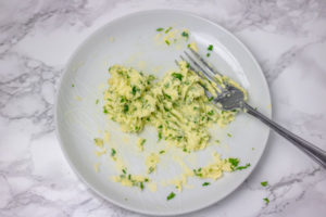 butter and herb mixture on a white plate.