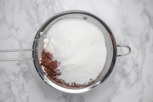 sugar and cocoa powder in a sieve.
