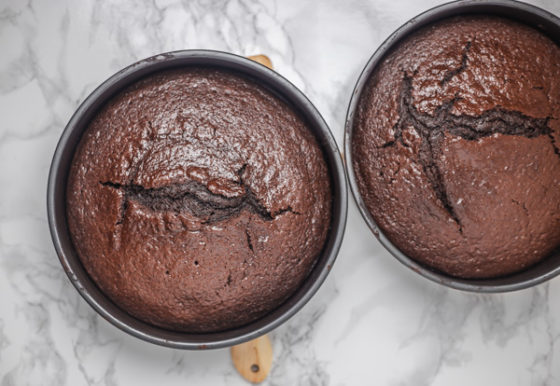 two chocolate cake in cake pans.