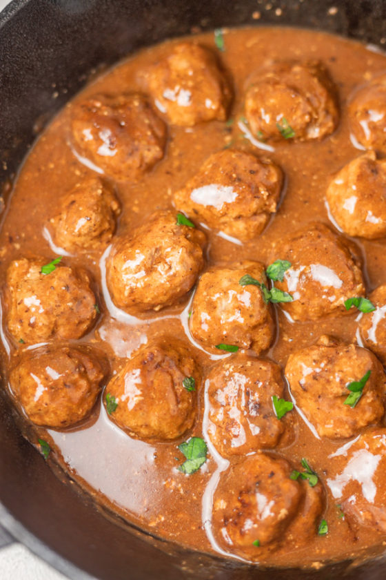 meatballs and gravy in a cast iron skillet.
