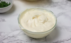 a small mixing bowl filled to the top with a creamy sauce.