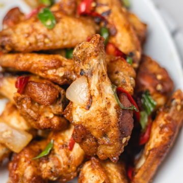 chicken wings and peppers on a plate.