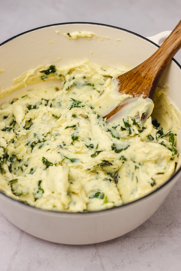a pot of mashed potatoes with greens.