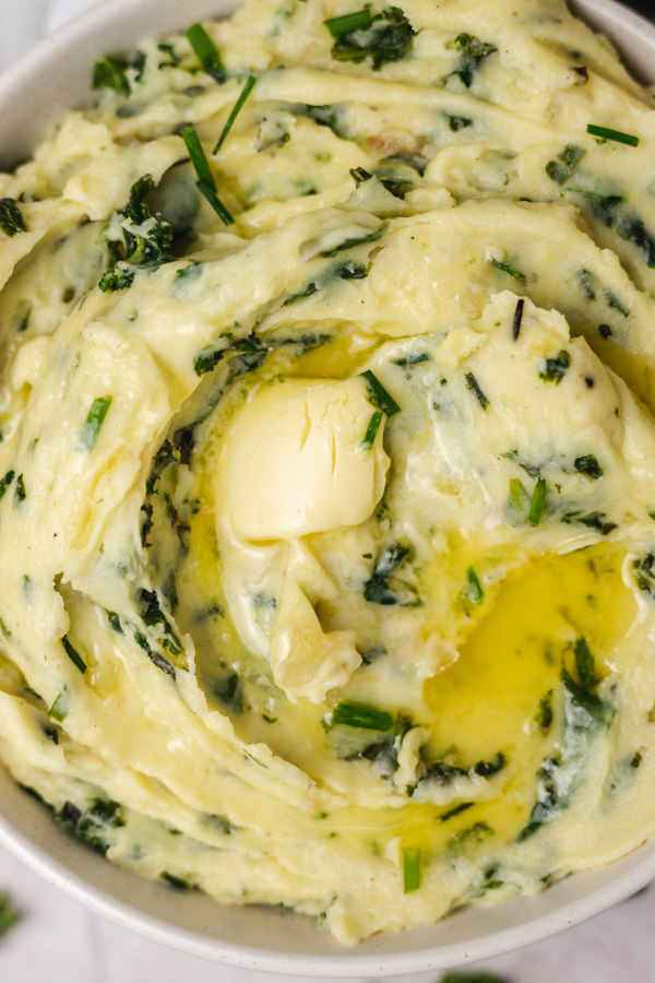 a bowl of kale mashed potatoes with melting knob of butter.