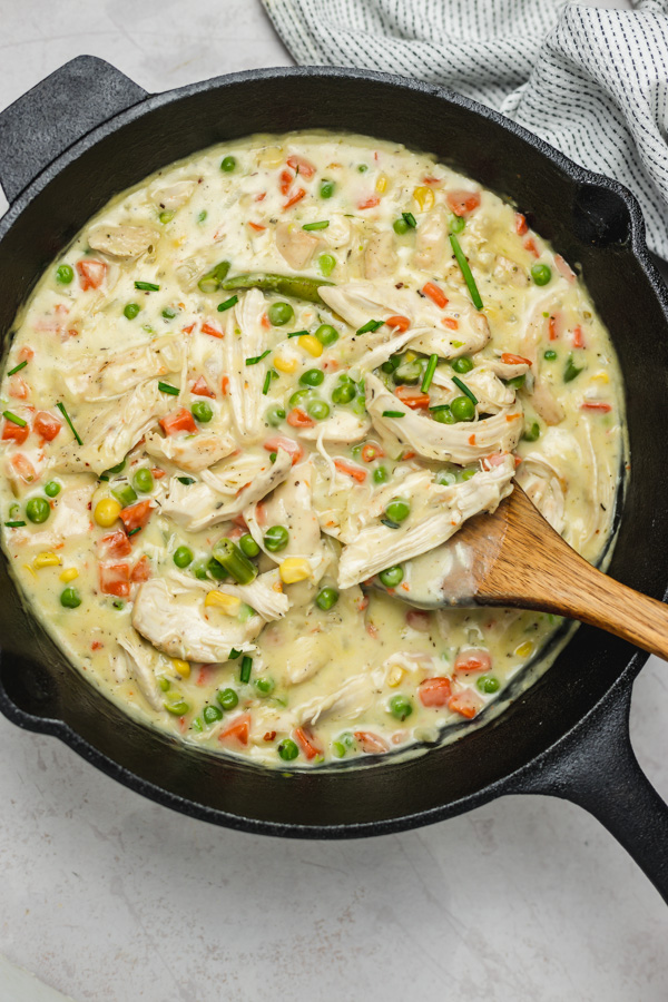 thick and creamy soup with veggies in a skillet.