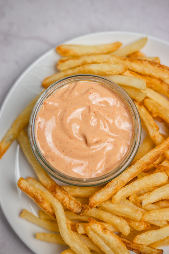 a platter of fries and a pot of dip.