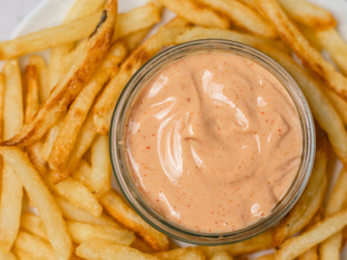 a plate of french fries and dipping sauce.