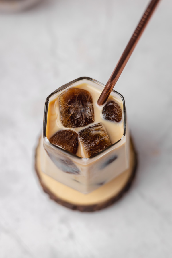 the top view of an iced coffee with a straw.