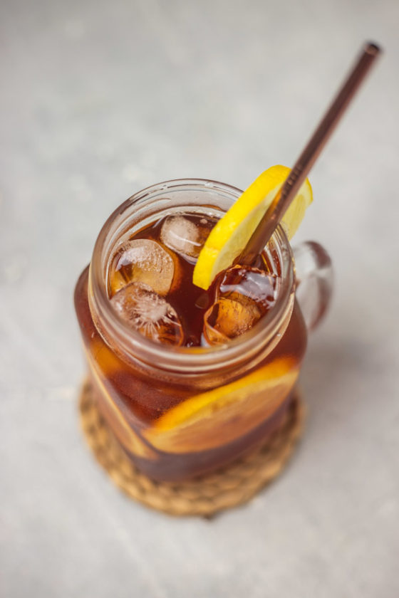 the overhead shot of lemon iced tea in a mason jar glass.