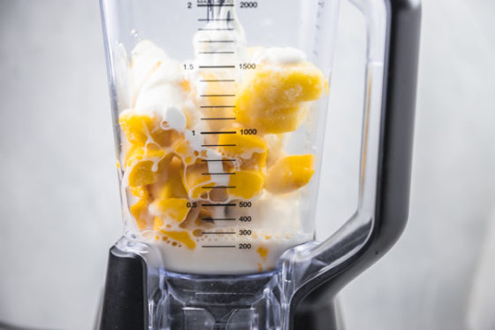 mango chunks, pineapple chunks and milk in a blender.