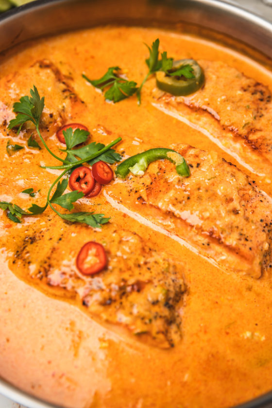 a close shot of a pan of salmon curry.