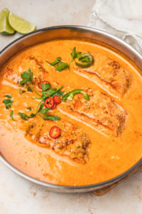 an overhead shot of salmon curry in a pan.
