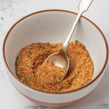 a teaspoon placed in a bowl of spice blend.