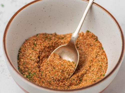 a teaspoon placed in a bowl of spice blend.